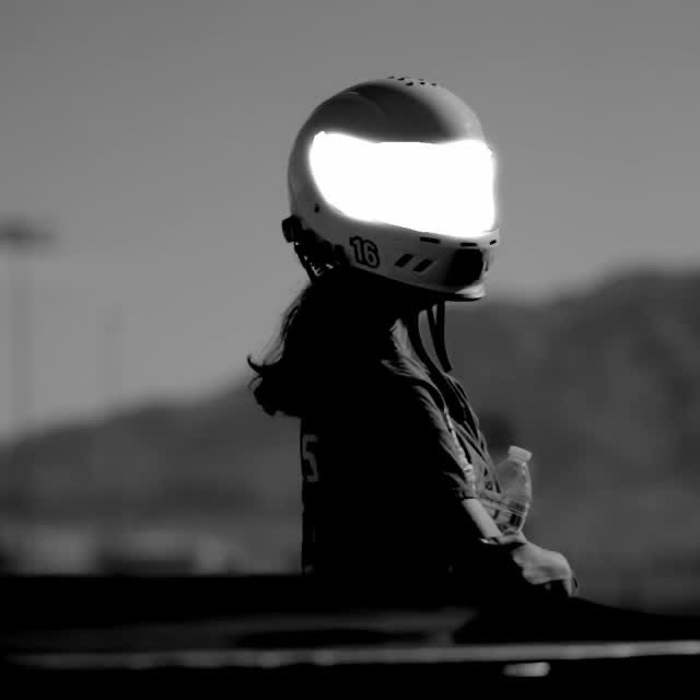 Helmeted performer under stage lighting