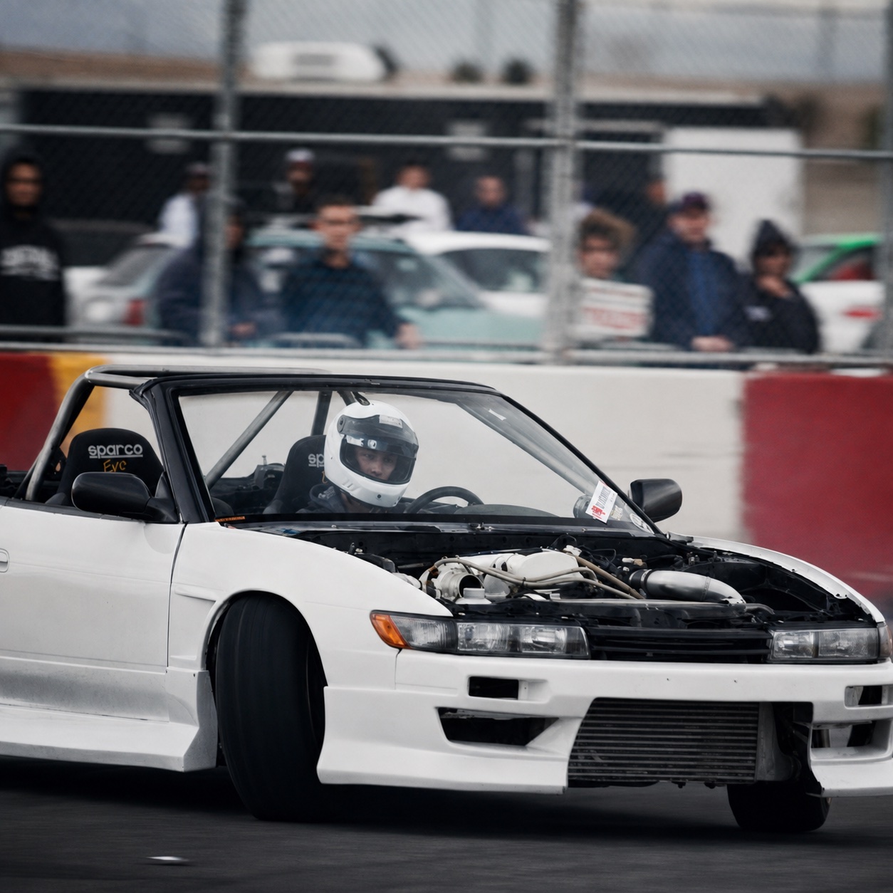 Jordan drifting a white car before beginning camera work
