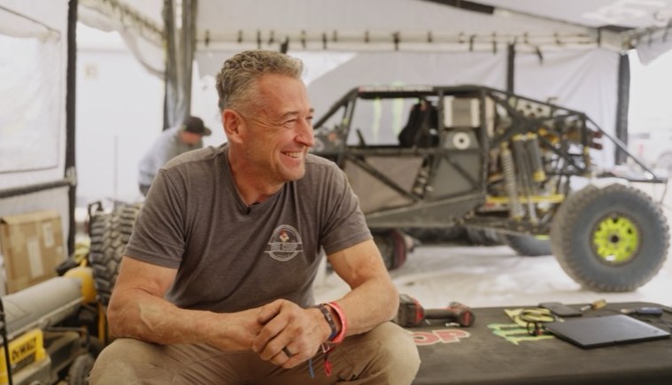 Shop interview with race vehicle behind