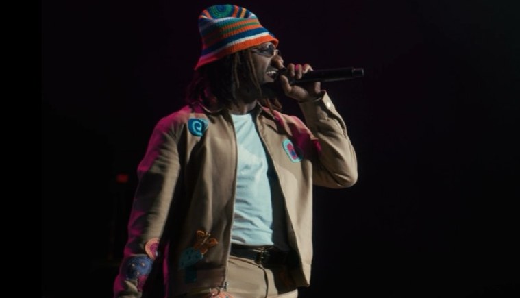 Performer facing a dark crowd